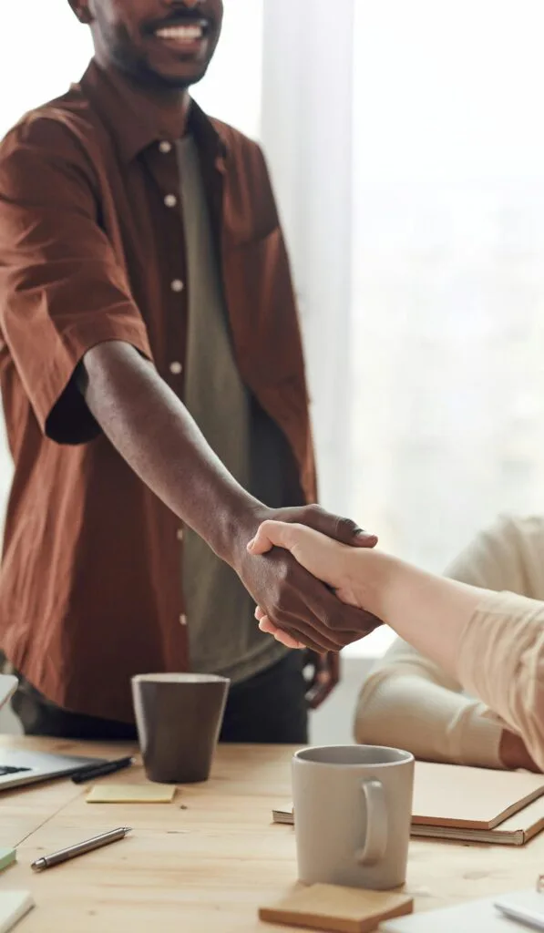 pexels-photo-3184578-3184578 Two colleagues shaking hands in a business meeting, symbolizing cooperation and agreement.